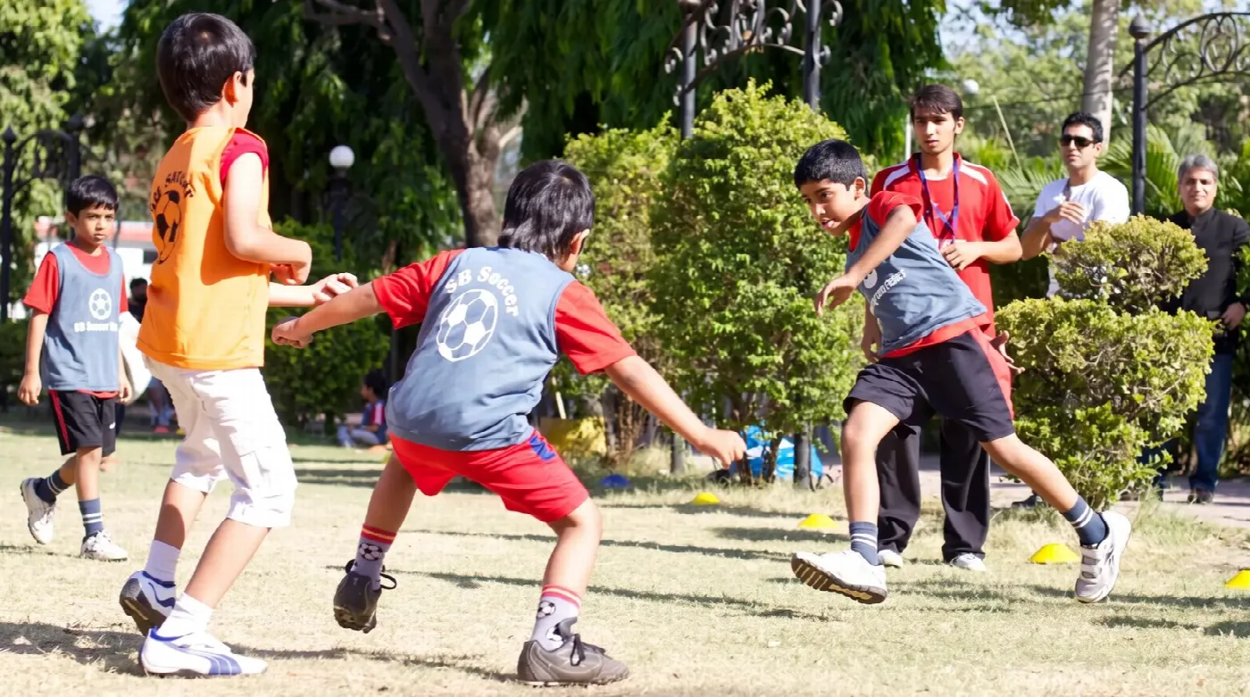 Children playing soccer at a SportyBeans multi-sport session