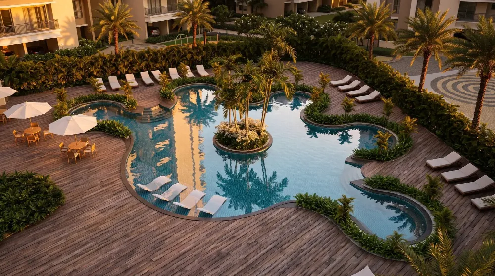 An infinity pool with loungers and a lit cafe pavilion at twilight